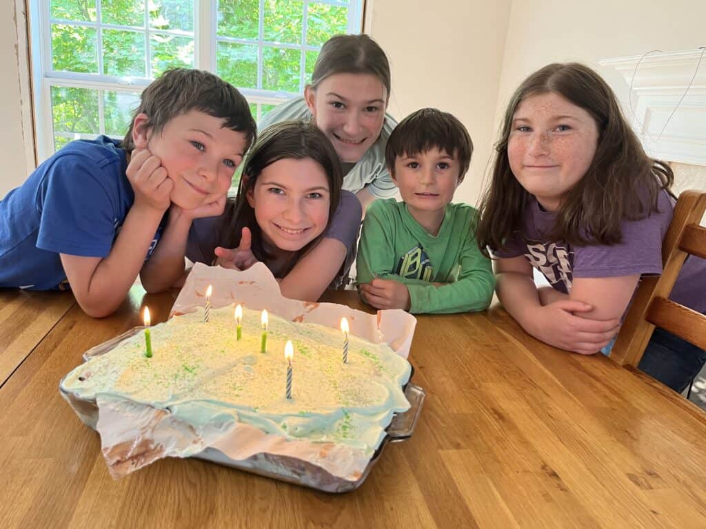 five of our kids gathered around their sister's birthday cake