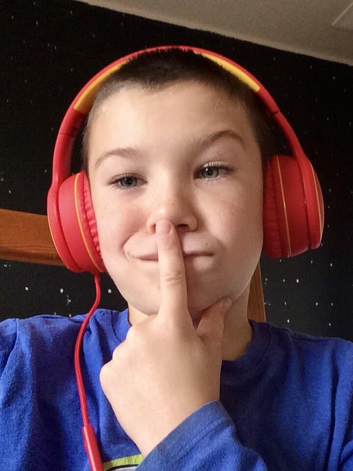 Our son wears red over-the-ear wired headphones.