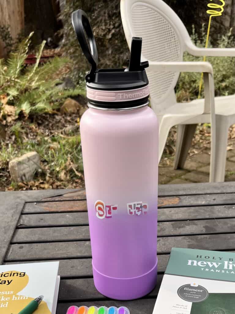 A pink and purple 32 oz. Thermoflask.