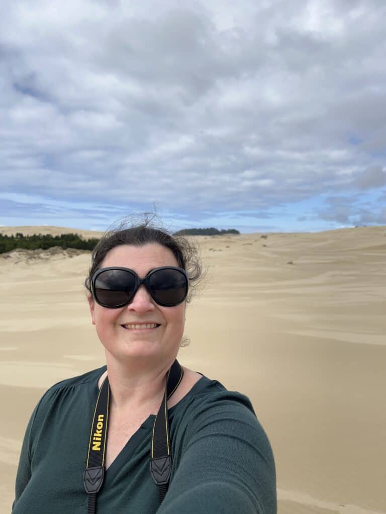 Jenn at the Oregon Dunes wearing sunglasses.
