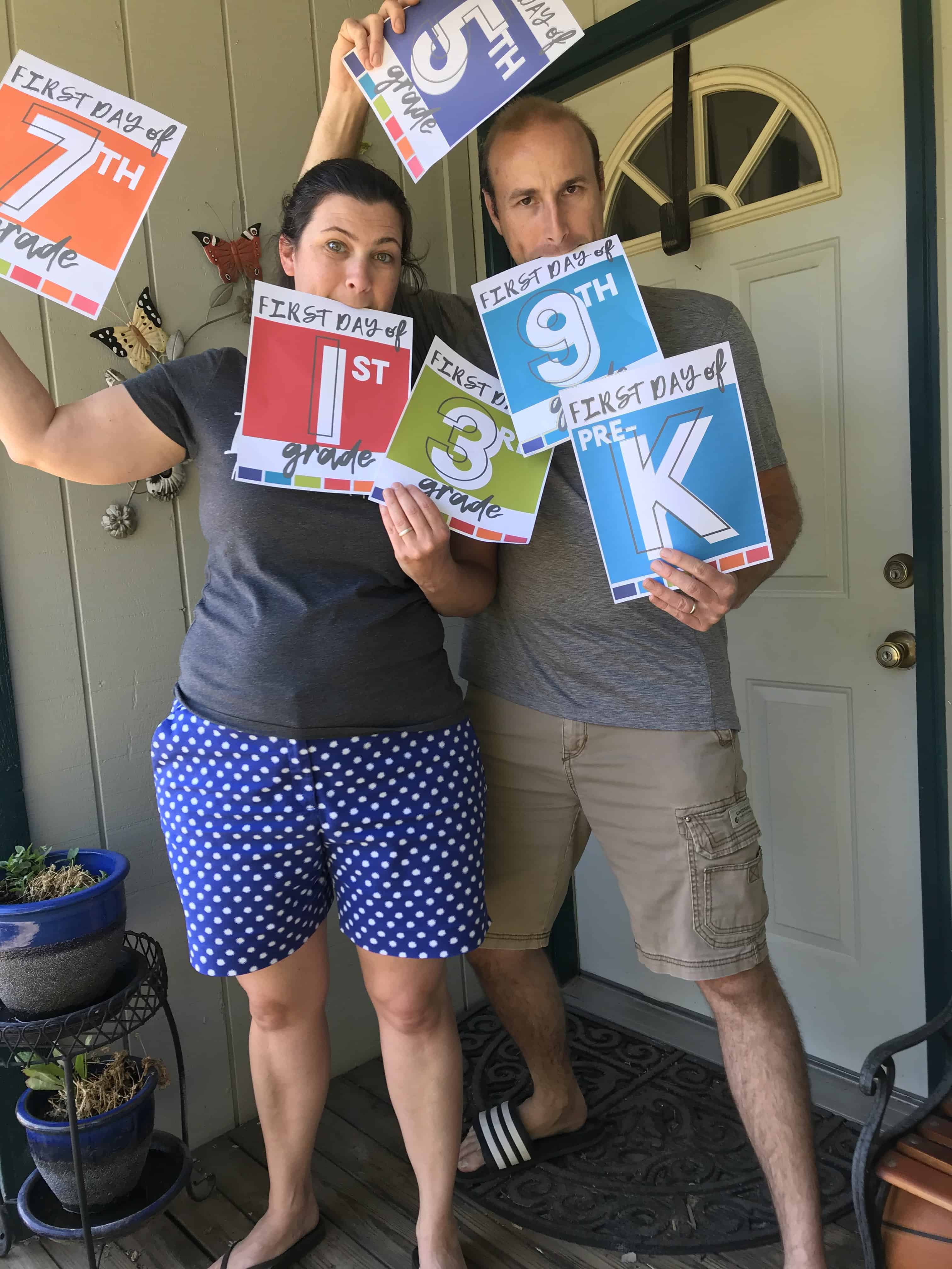 mom and dad holding grade signs. Back to School Homeschool Ideas