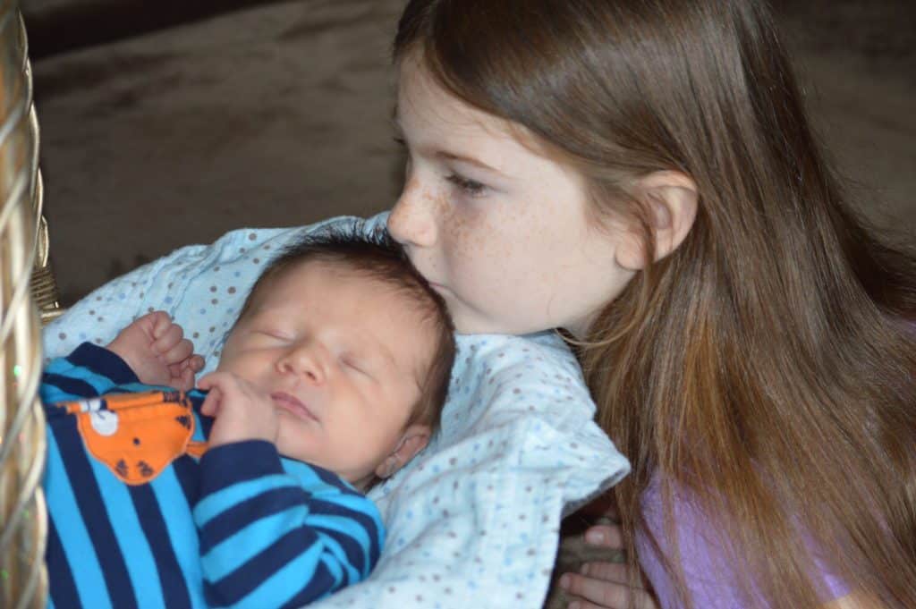 child kissing baby