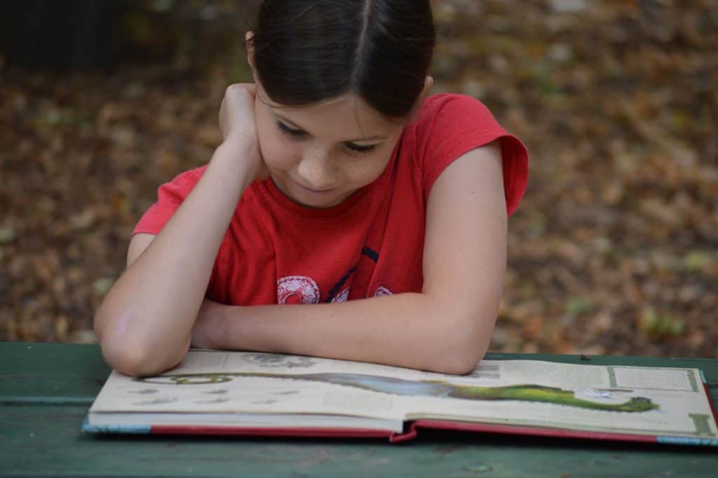 girl lost in a book - a typical feature of ADHD