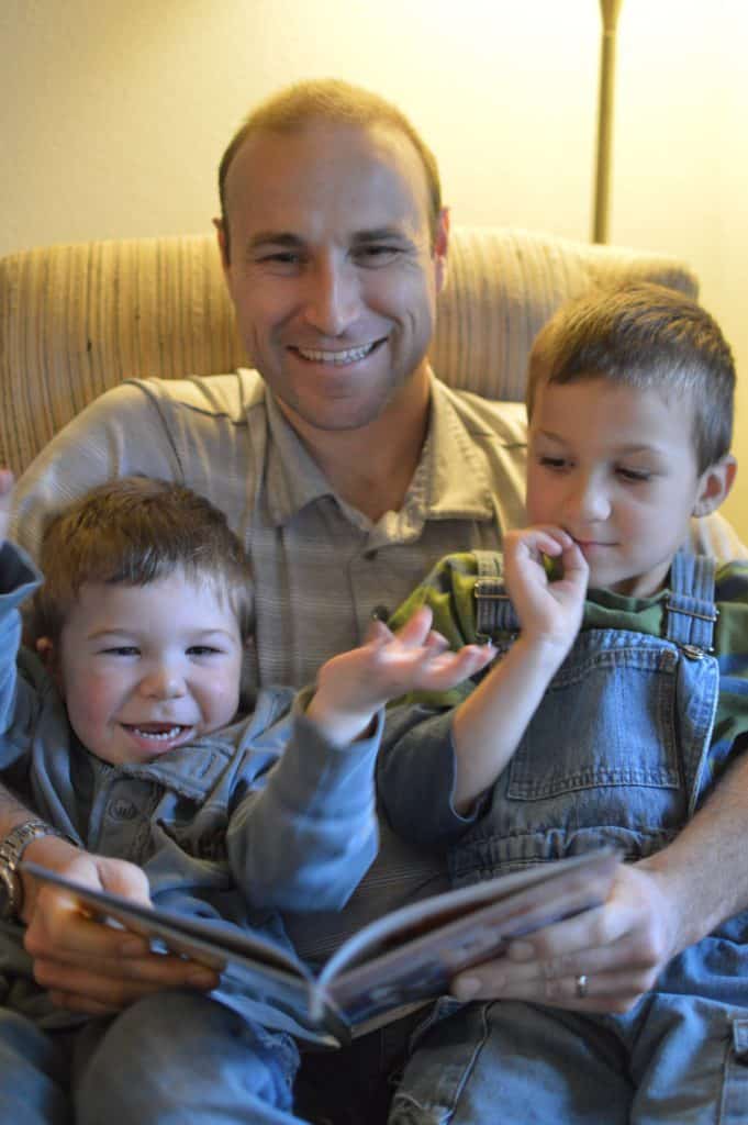 man reading with boys in lap. Taking medication for Adult ADHD didn't change Brian's personality.