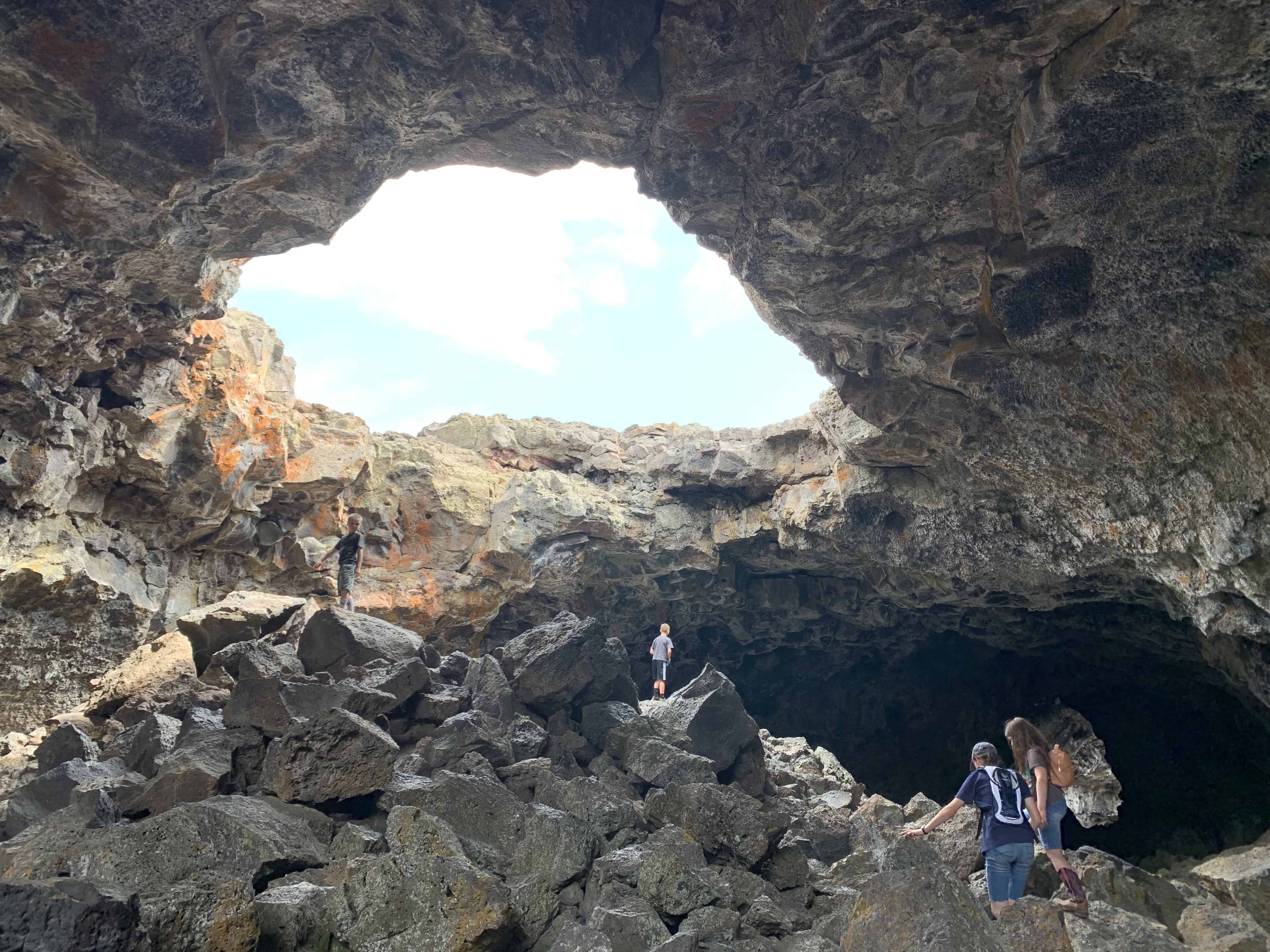 kids exploring inside of Indian Cave at Craters of the Moon NM
