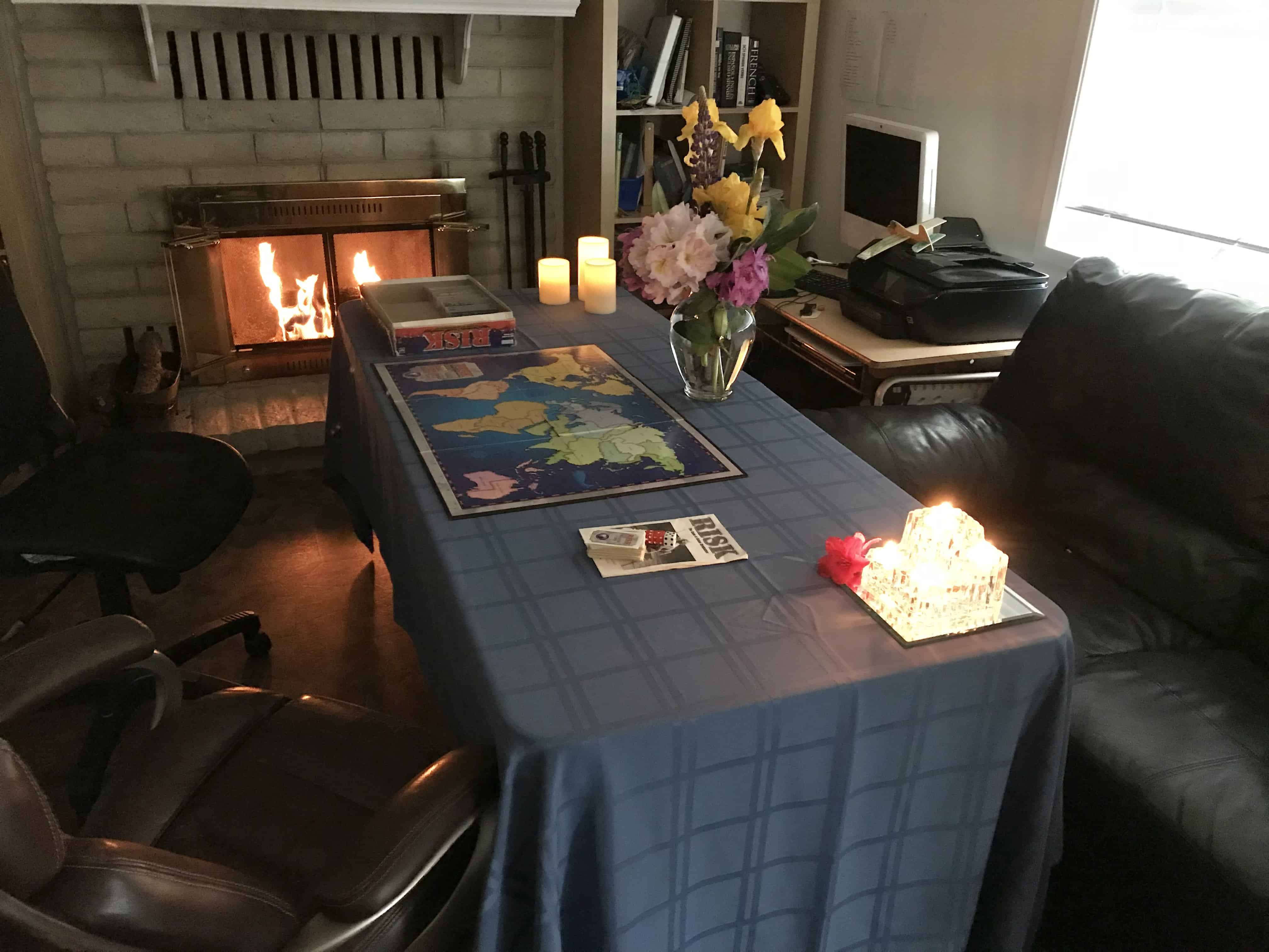 Date night at home set up with candles, fireplace, board game. Date Night for Married Couples.