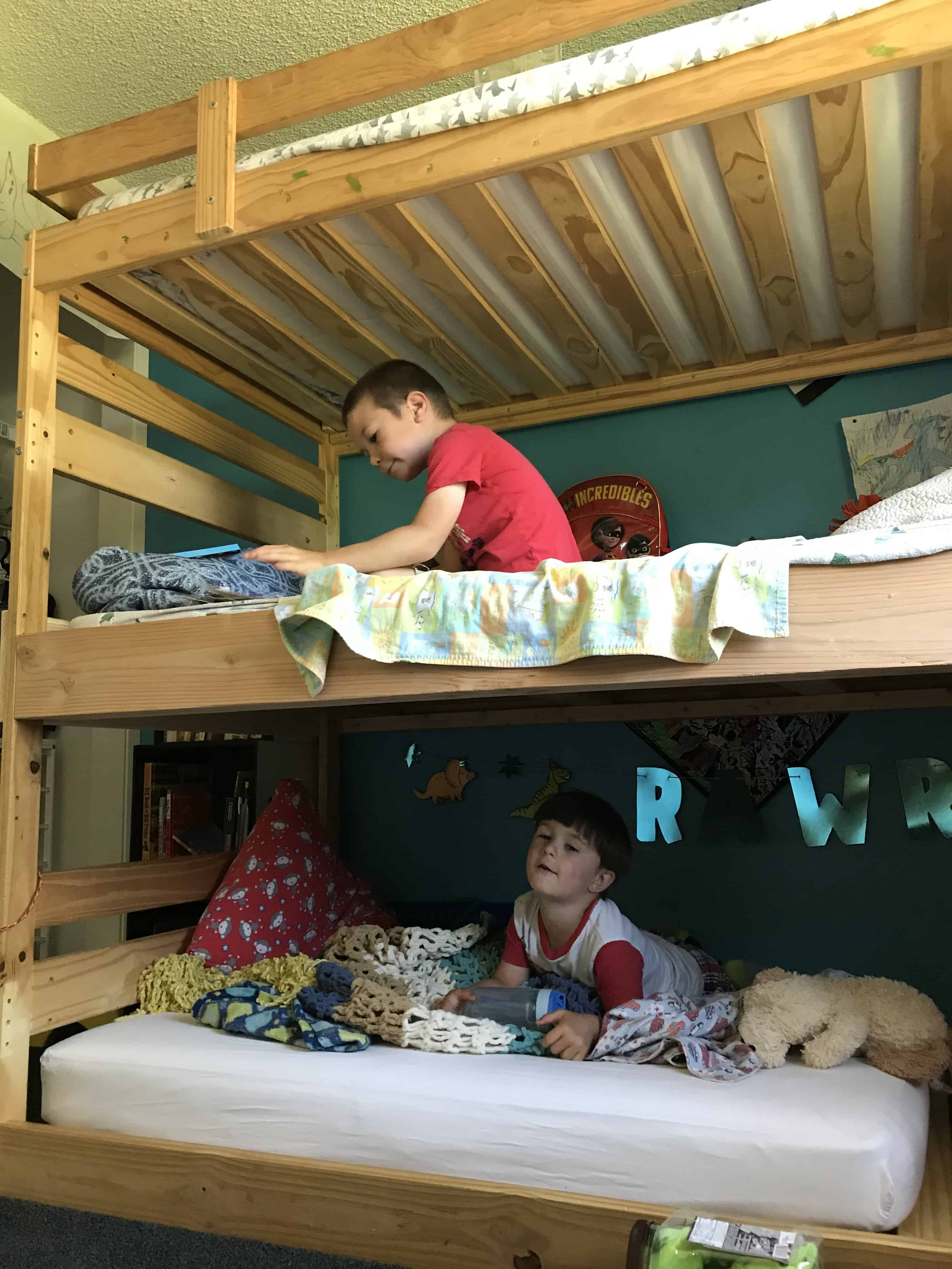 Boys on bunk bed in preparation for at-home date night. Date nights for married couples.