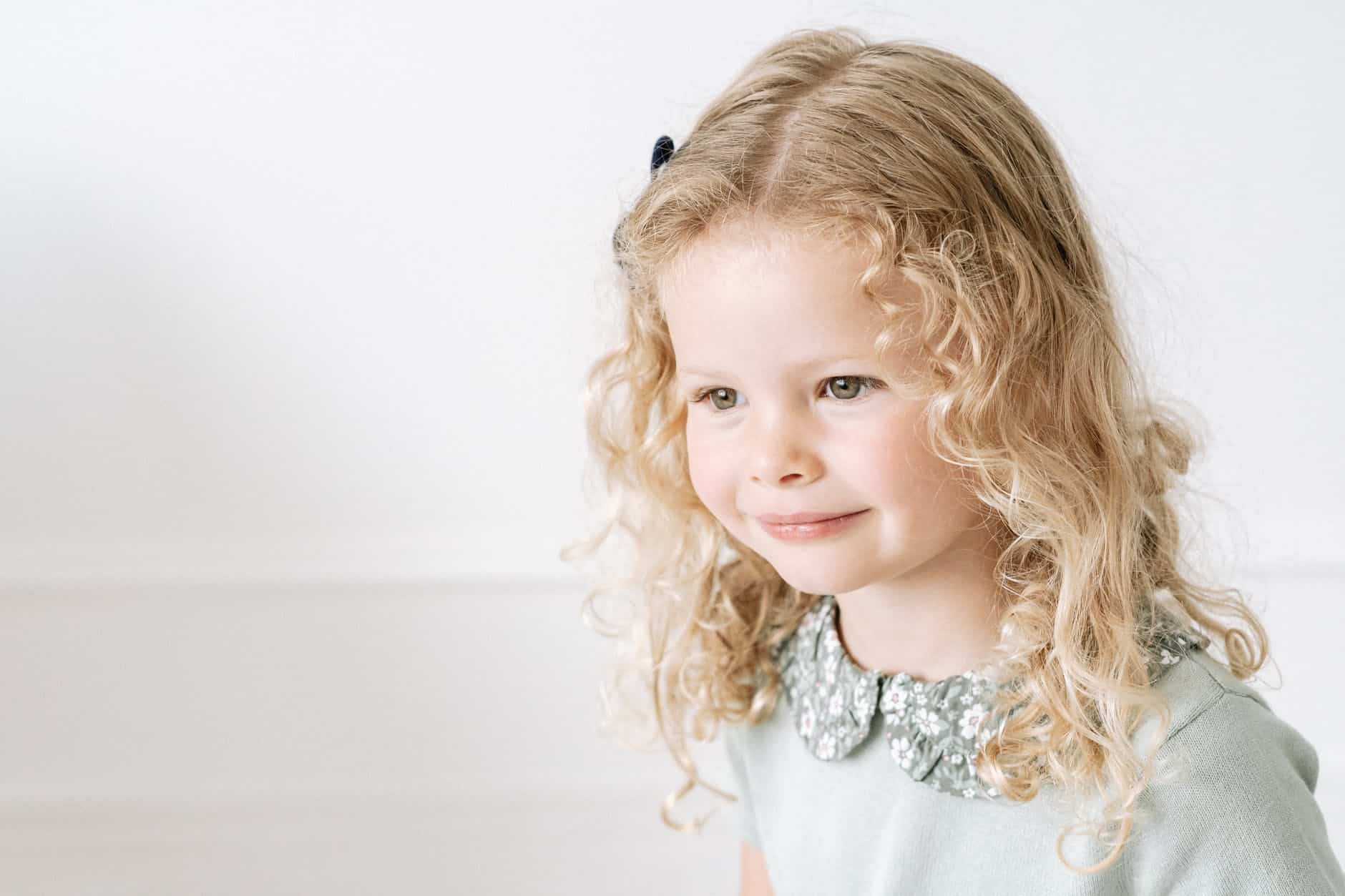 child with curly blond hair