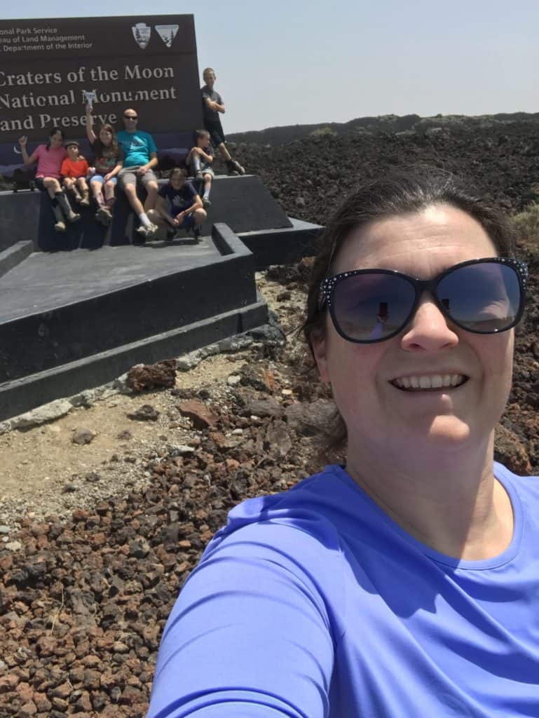 Family at the entrance to Craters of the Moon National Monument and Preserve