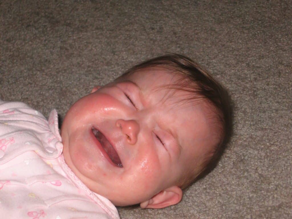 Baby crying. Having a new baby can make it even more difficult to create space for grief during the holidays.