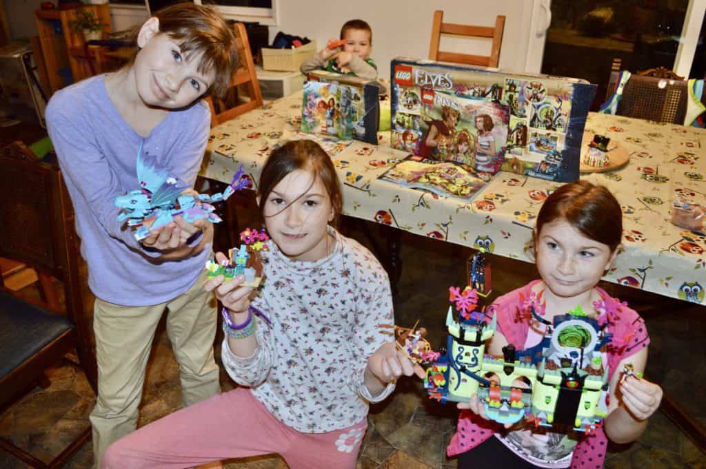 girls holding lego sets. Legos are always great gifts for kids!