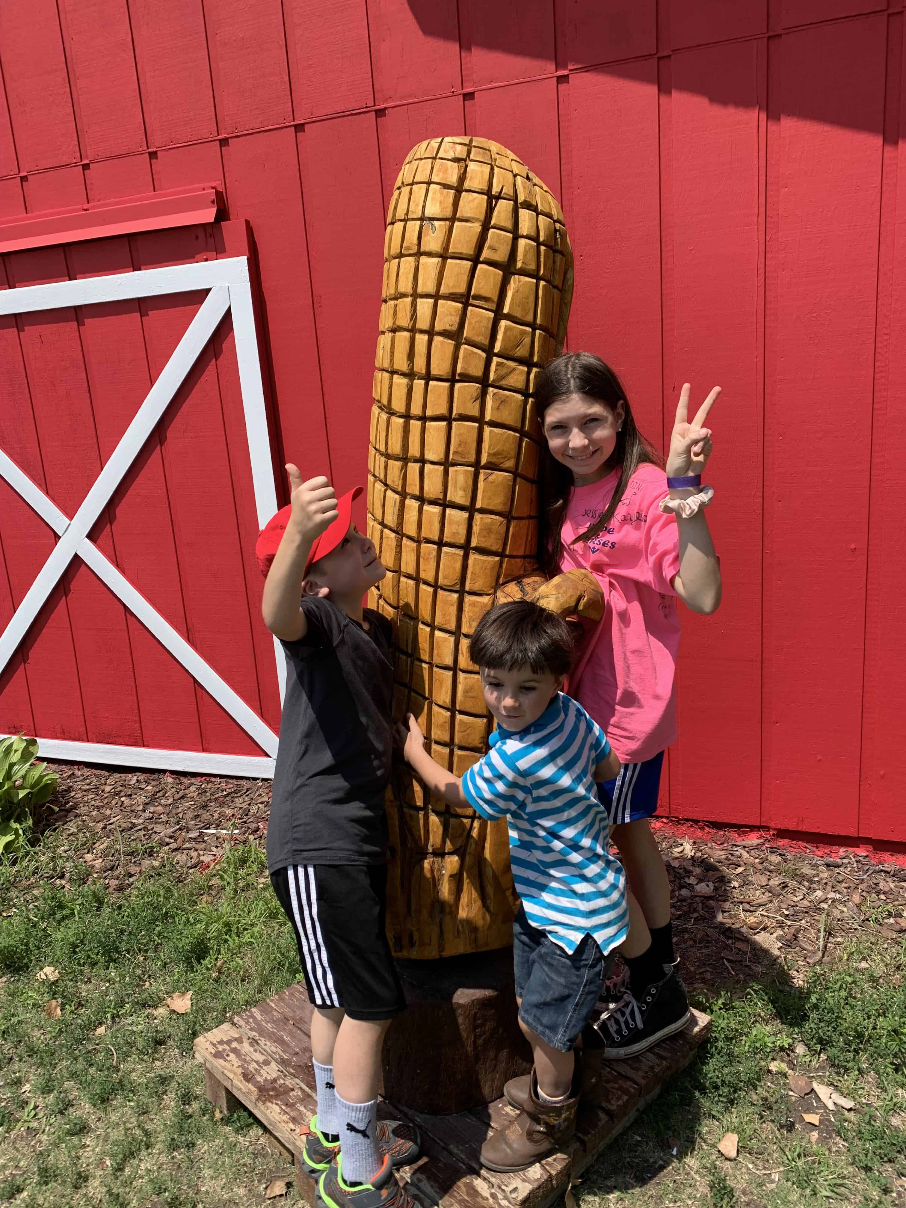 kids in front of giant corn cob