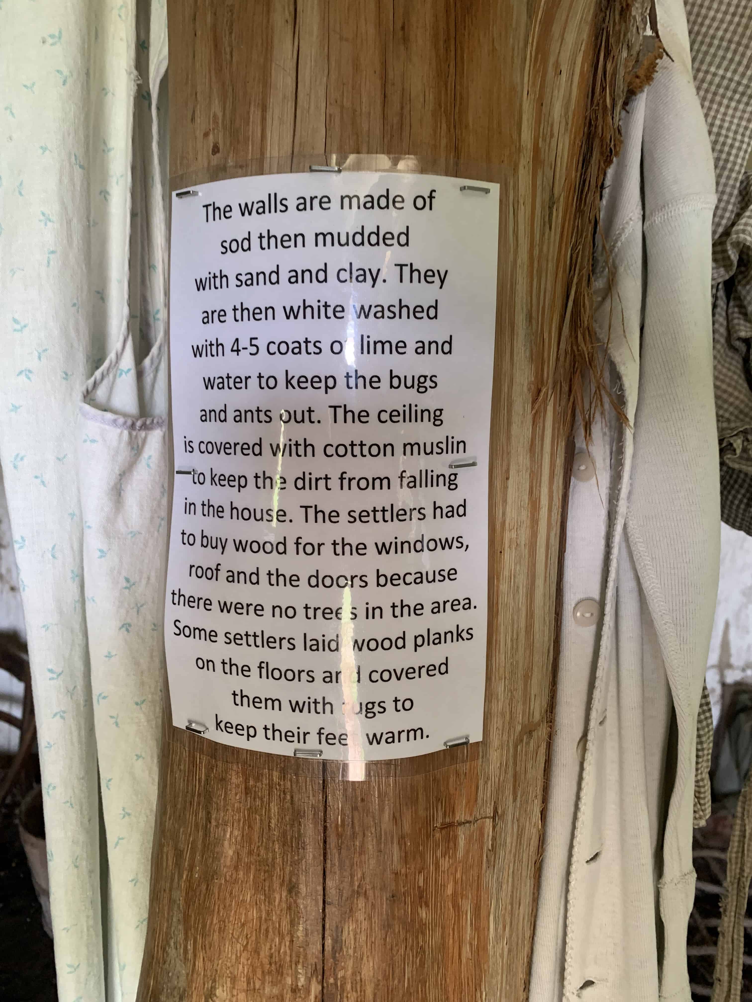 paper sign on post describing how a sod house was built