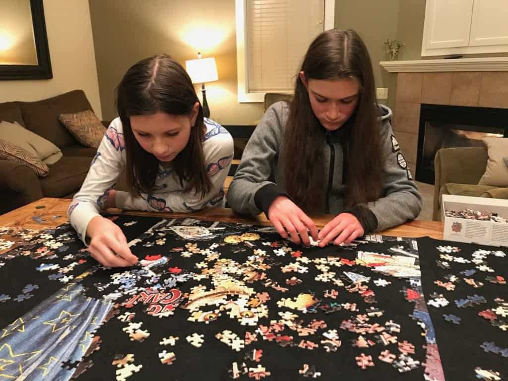 teen girls woking on jigsaw puzzle