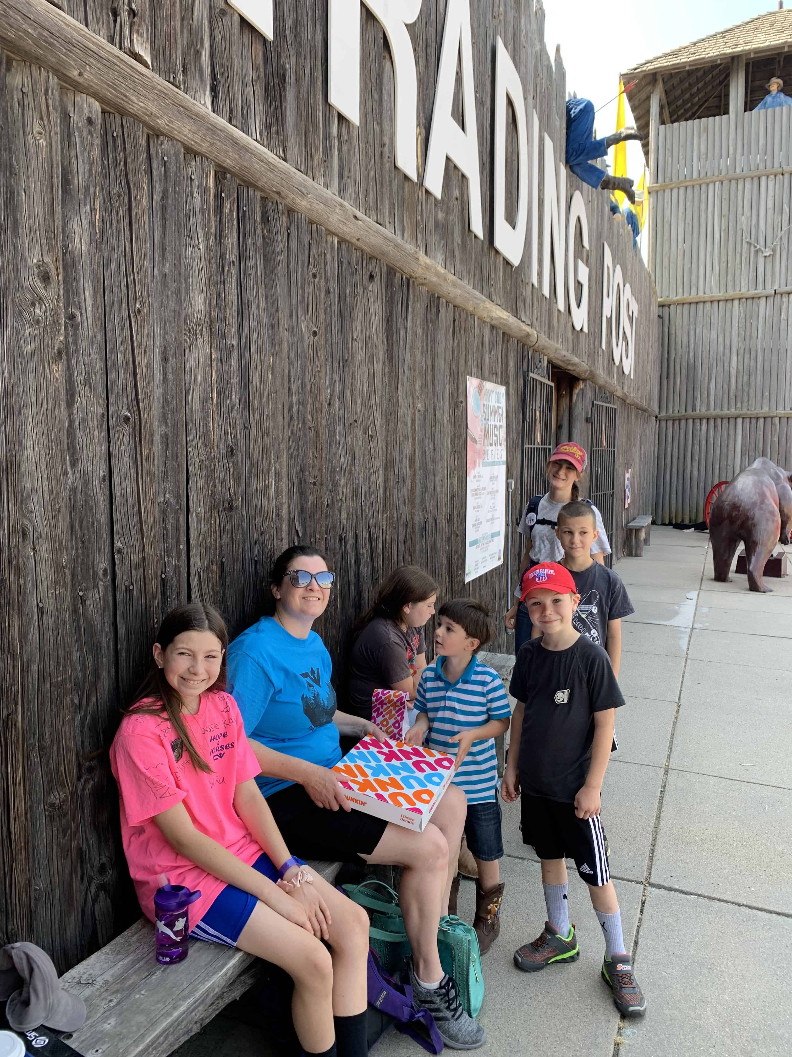 family on a bench outside Fort Cody