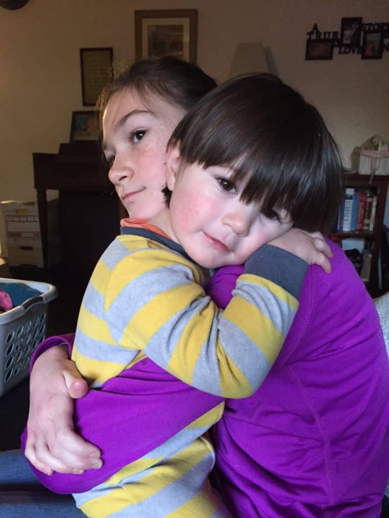 Toddler hugging girl. Physical affection can be a huge help in alleviating grief during the holidays.