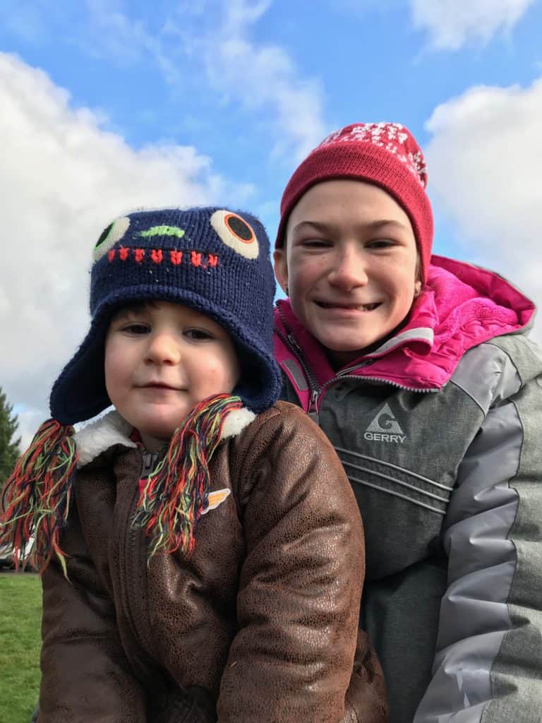 Girl and boy in jackets and hats