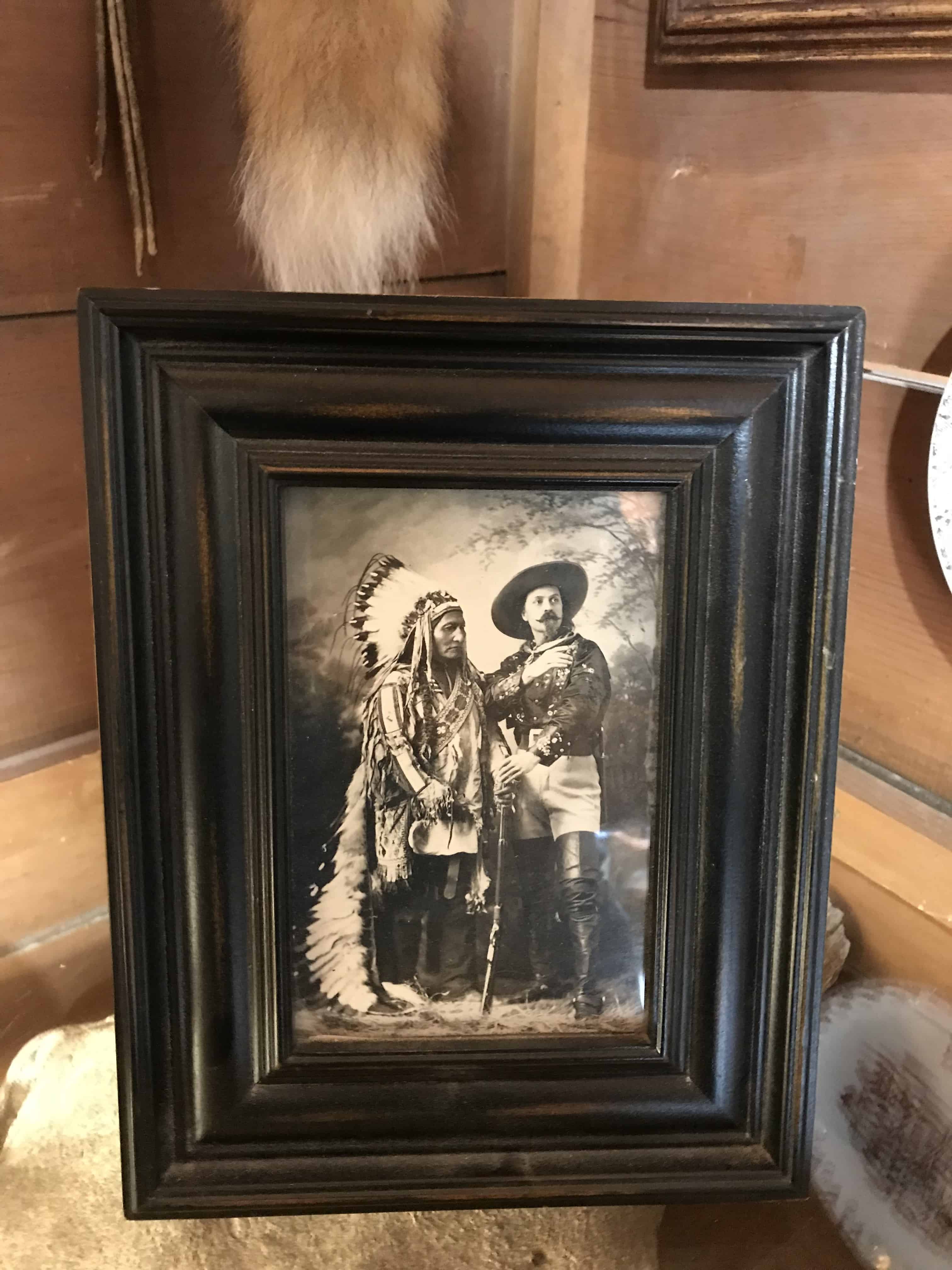 Black and white framed photo of cowboy with indigenous chief. Property of the Sod House Museum.