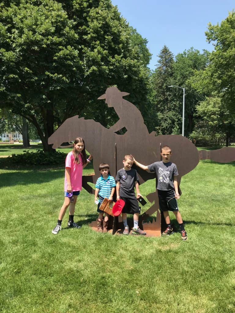 Our children make funny faces in front of metal silhouette of a Pony Express Rider. You can find all of the national trails on Dinkum Tribe's list of national parks and monuments by state. 