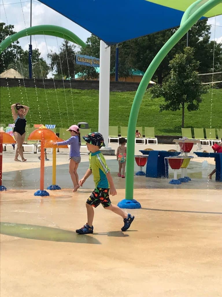 Our youngest son in swimsuit running across the splash pad area.