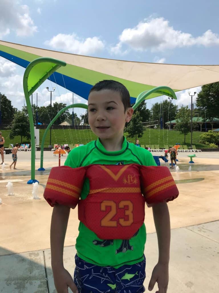 boy at waterpark with life jacket