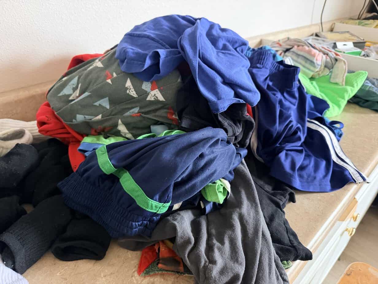 Clean laundry often sits in a pile like this for days at our house because there are so many steps involved in getting it put away.