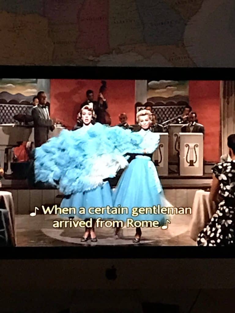screenshot of scene from White Christmas with closed captions on