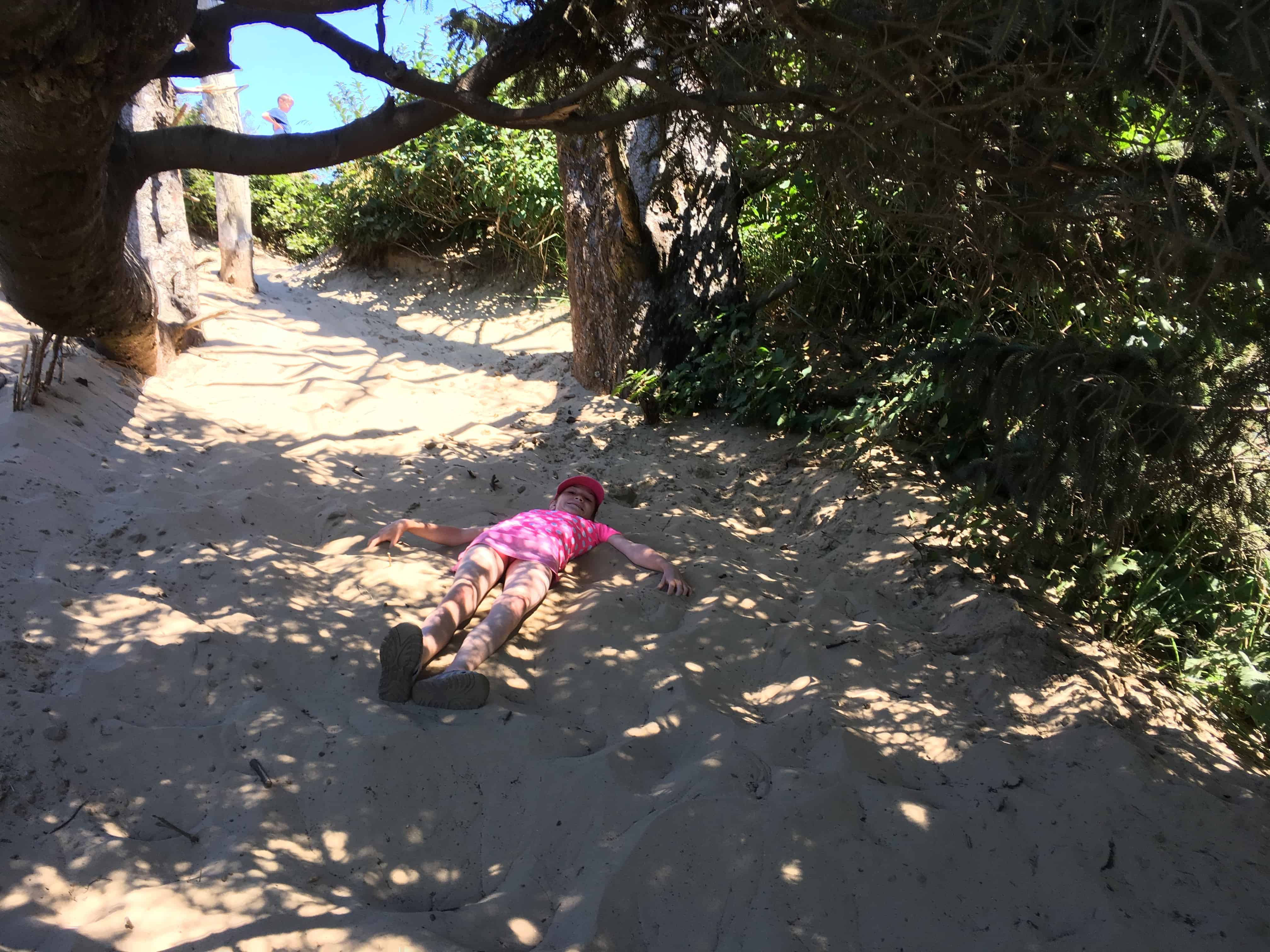 Cooling off in the grove that tops the Cape Kiwanda dune. Exploring Pacific City Oregon with kids.