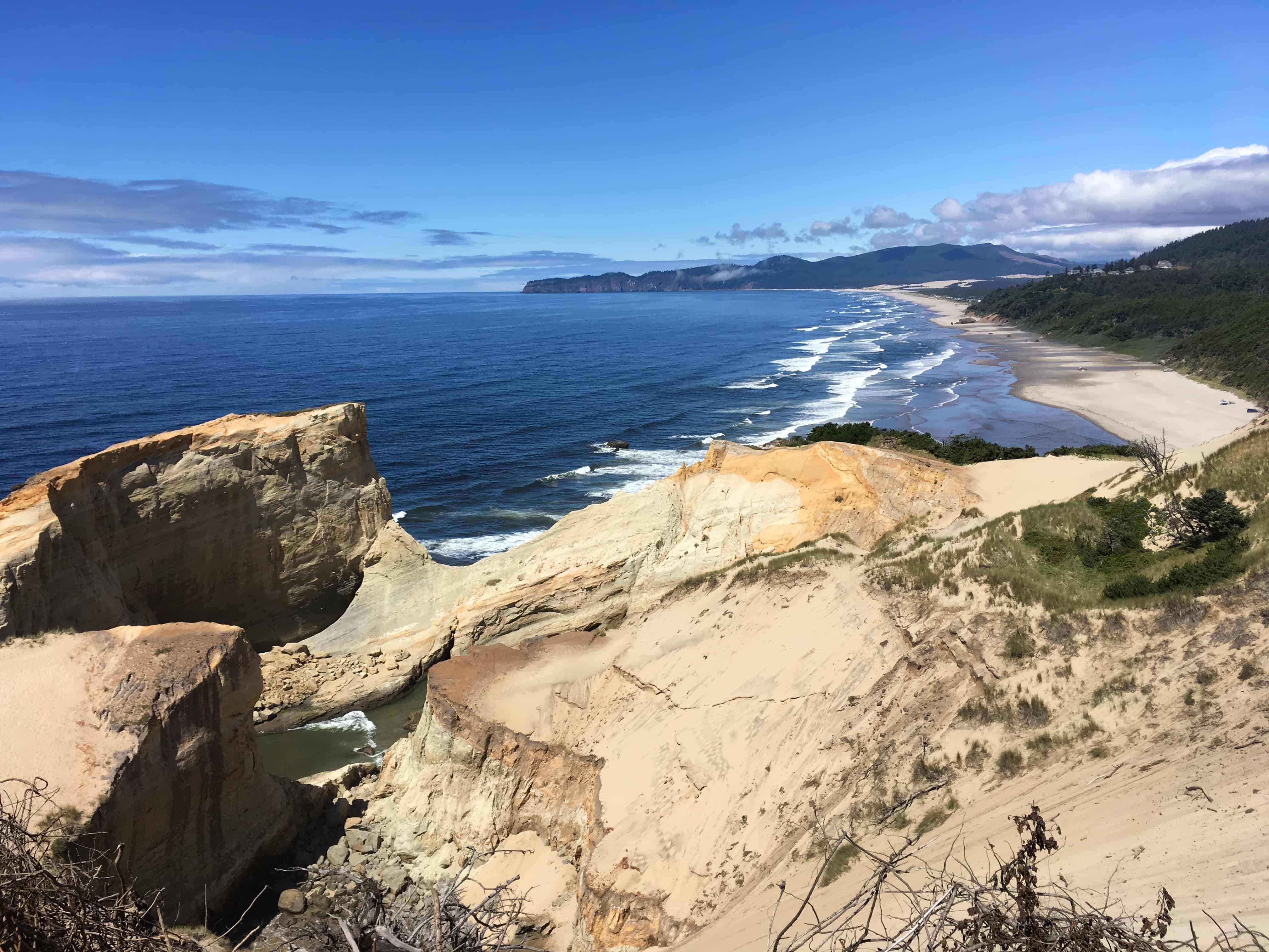 Beautiful bluffs and Oregon coastline. Visiting Pacific City, Oregon with kids is a great summer activity.