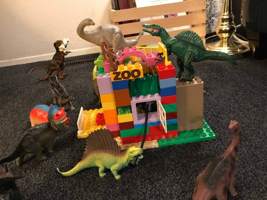 Zoo for the dinosaurs made out of LEGO Duplos. LEGO challenges, like building a zoo, are easy activities for kids of all ages.
