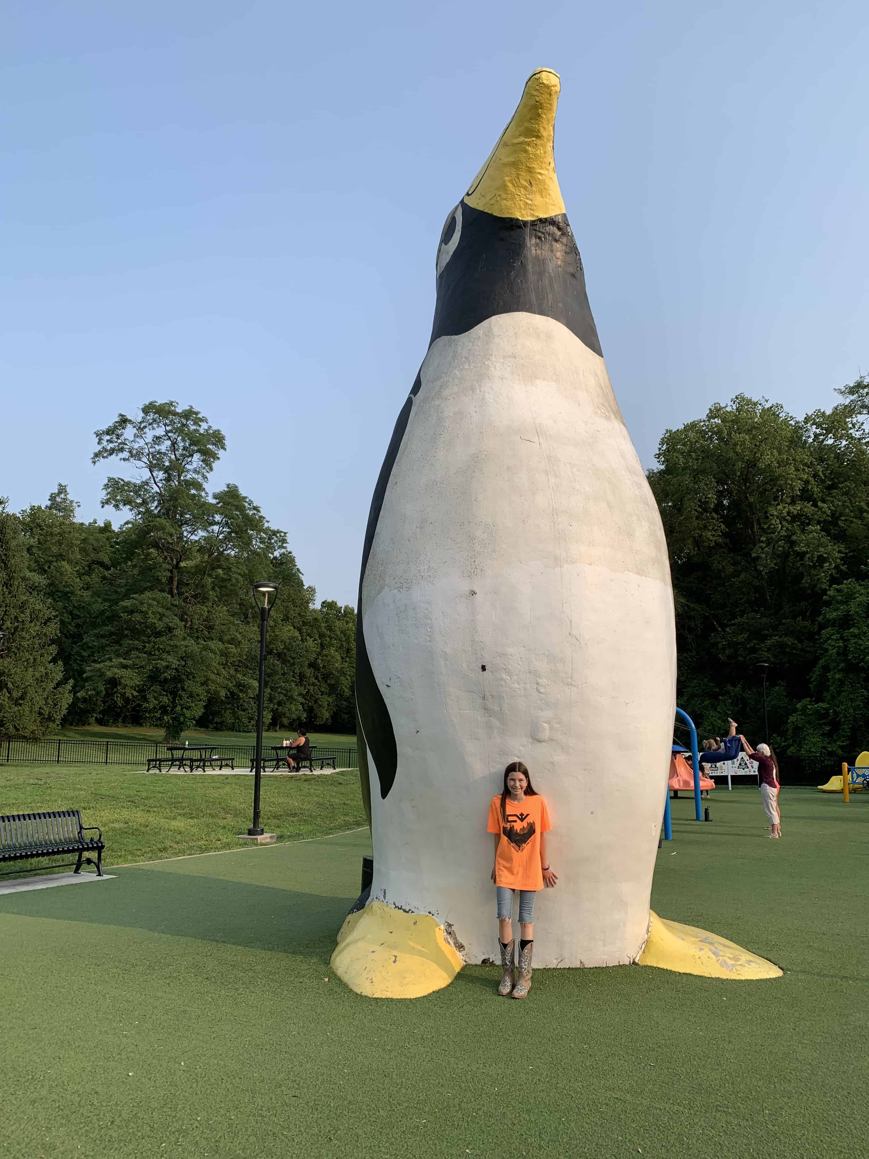 Girl in front of penguin at the Penguin Park in Kansas City, MO