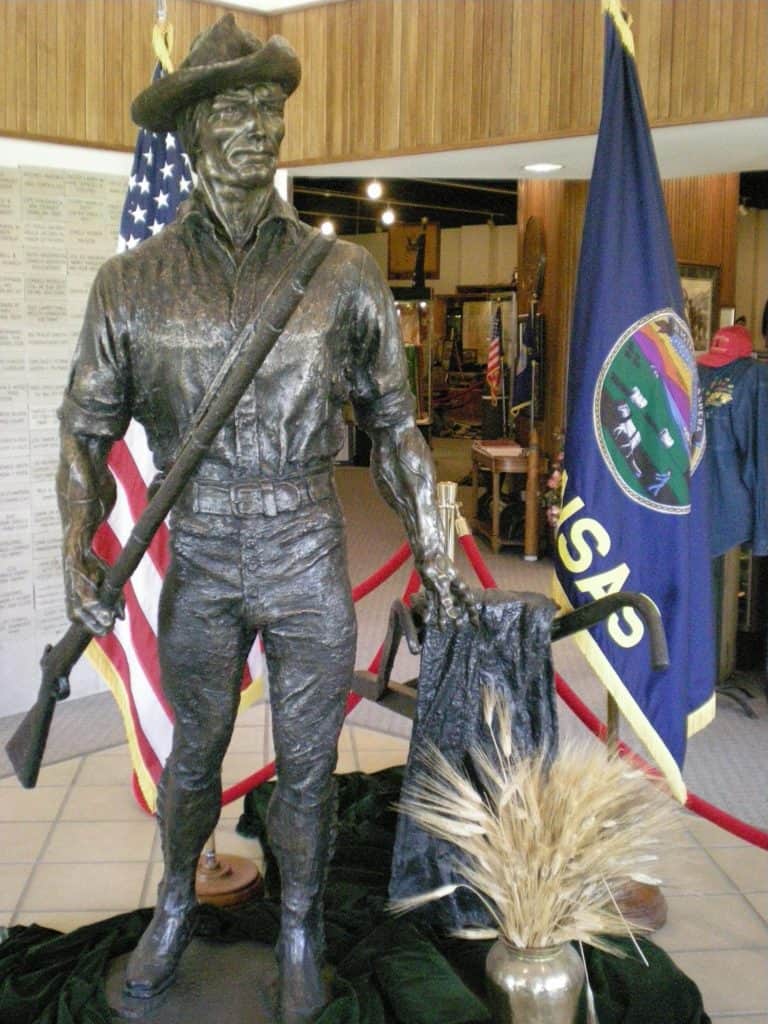 A bronze militiaman statue stands at the entryway of the Museum of the Kansas National Guard.