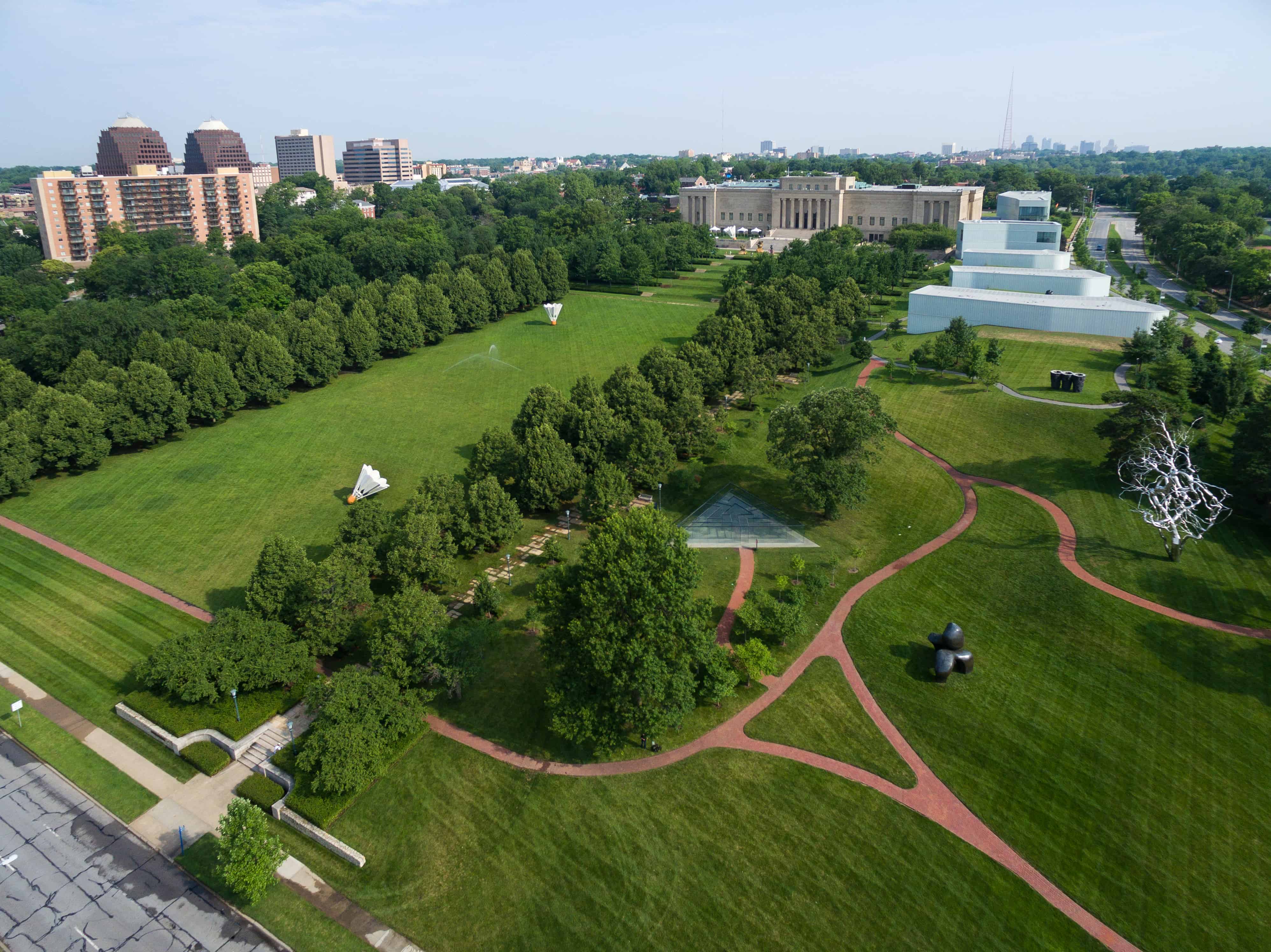 A bird's eye view of the Nelson-Atkins Museum of Art. Enormous sculptures decorate the green parkland surrounding the museum.