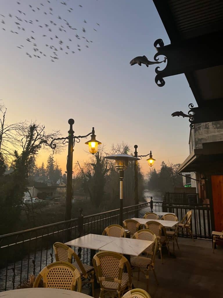 Back balcony seating area at the Noble Fox, overlooking Silver Creek in Silverton, Oregon.