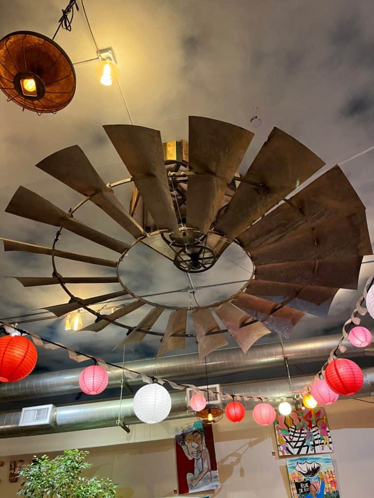 Windmill, colorful paper lanterns, and local artwork provide cheerful decor at Taproot, a cafe in Salem, Oregon.