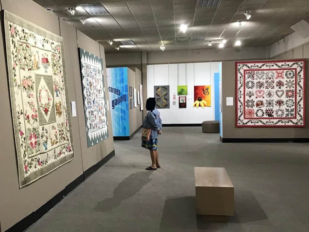 Person standing in National Quilt Museum gallery.