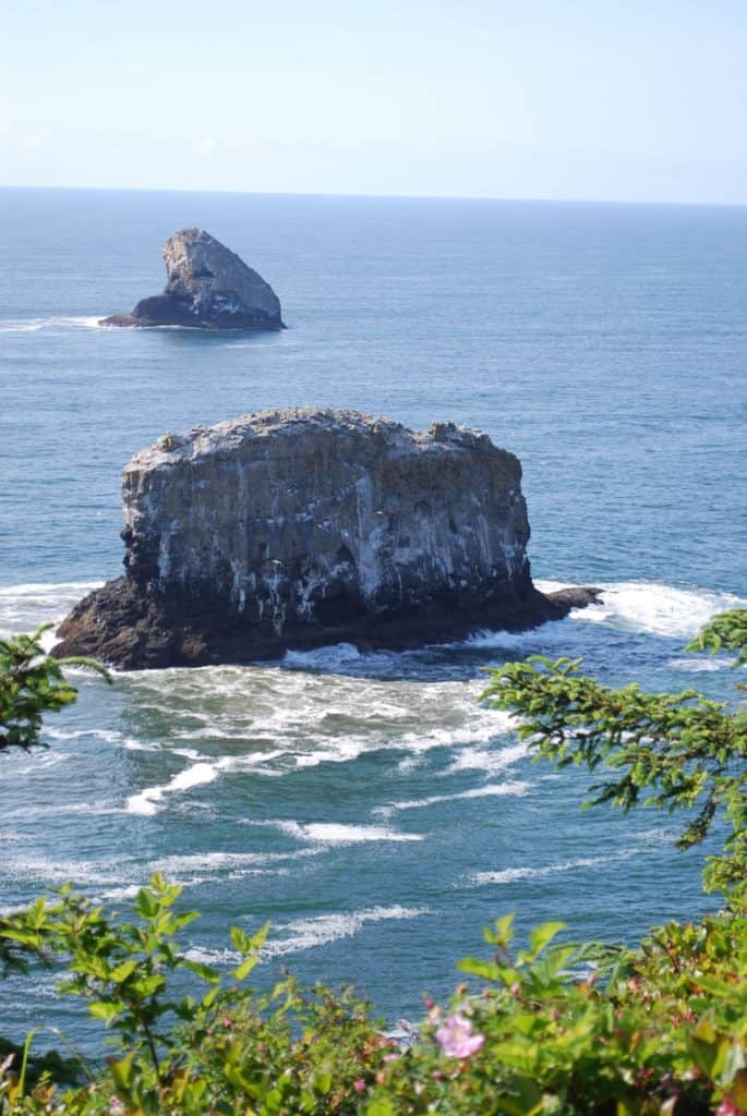 Two beautiful sea stacks stand amid ocean waves at Cape Meares National Wildlife Refuge. Cape Meares NWR is right next to Short Beach. Short Beach is one of the best agate beaches in Oregon.