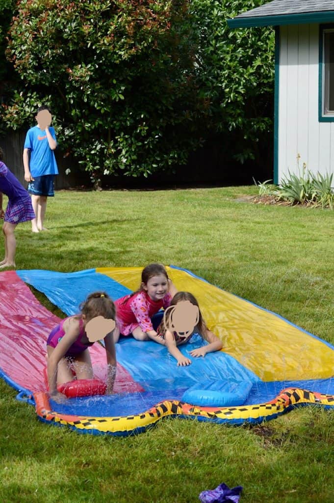 Kids on slip and slide. Slip and slides are some of the best active gifts for kids.