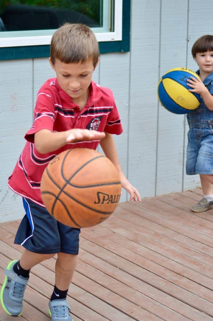 Boys dribbling basketballs. Basketballs make excellent active gifts for kids.