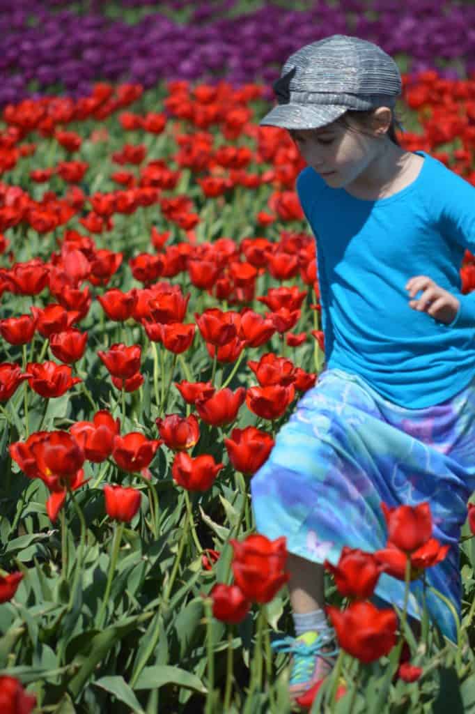 Girl running through tulips. Hyperactive ADHD type often looks like boundless energy.