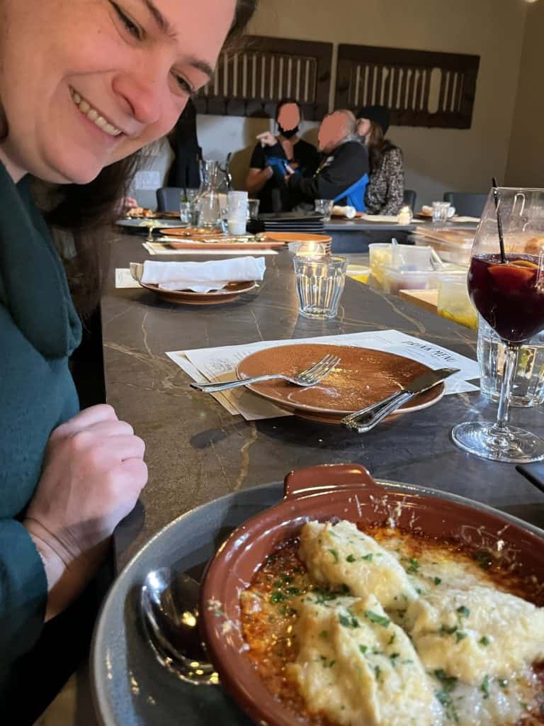 Woman looking at goat cheese dumplings with arrabbiata