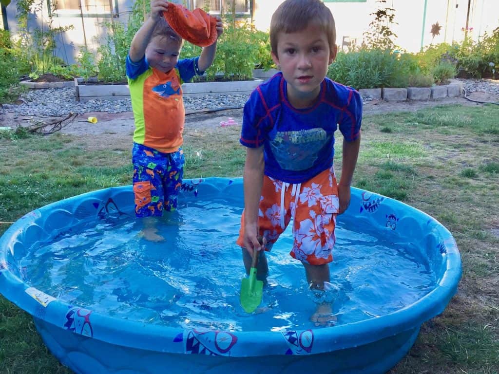 Boys in plastic kiddie pool. Kiddie pools are great active gifts for kids.