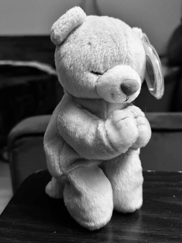 Stuffed bear in praying position. Prayer and meditation can help greatly with anxiety, and should be included in a self-care routine for anxiety.