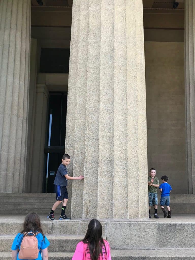 Kids running around the base of the Nashville Parthenon's columns.