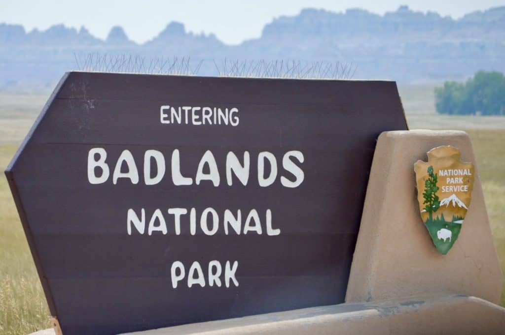 Sign says "Entering Badlands National Park". Driving through Badlands National Park is a great way to see a lot of the park in a short amount of time.