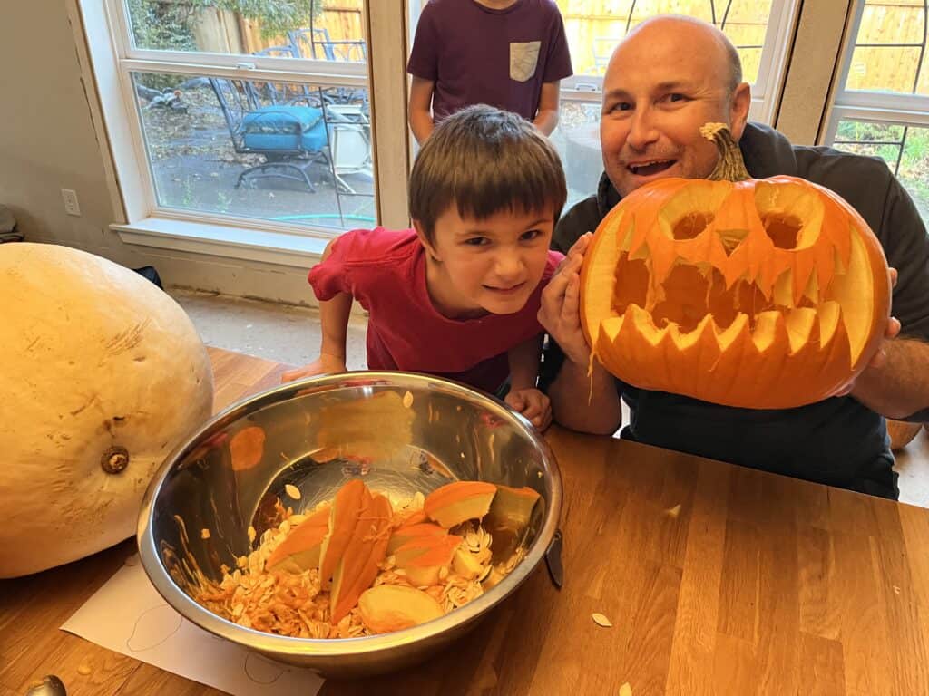 Brian and our son goofing around while carving a jack-o-lantern