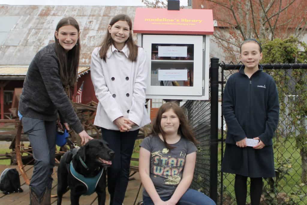 Girls in front of Little Library. Madeline's Library is a fun stop along the Beverly Cleary Walk in Yamhill. A fun thing to do near McMinnville with kids.