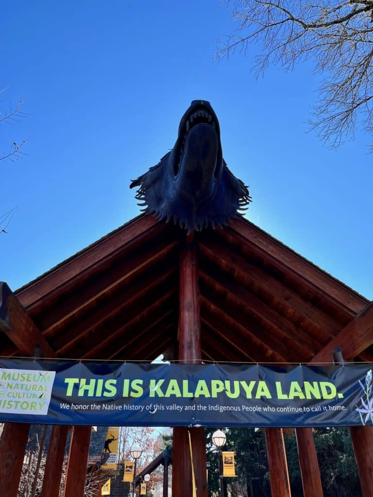 Sign saying, "This is Kalapuya land" below wolf's head at the Natural History Museum in Eugene.