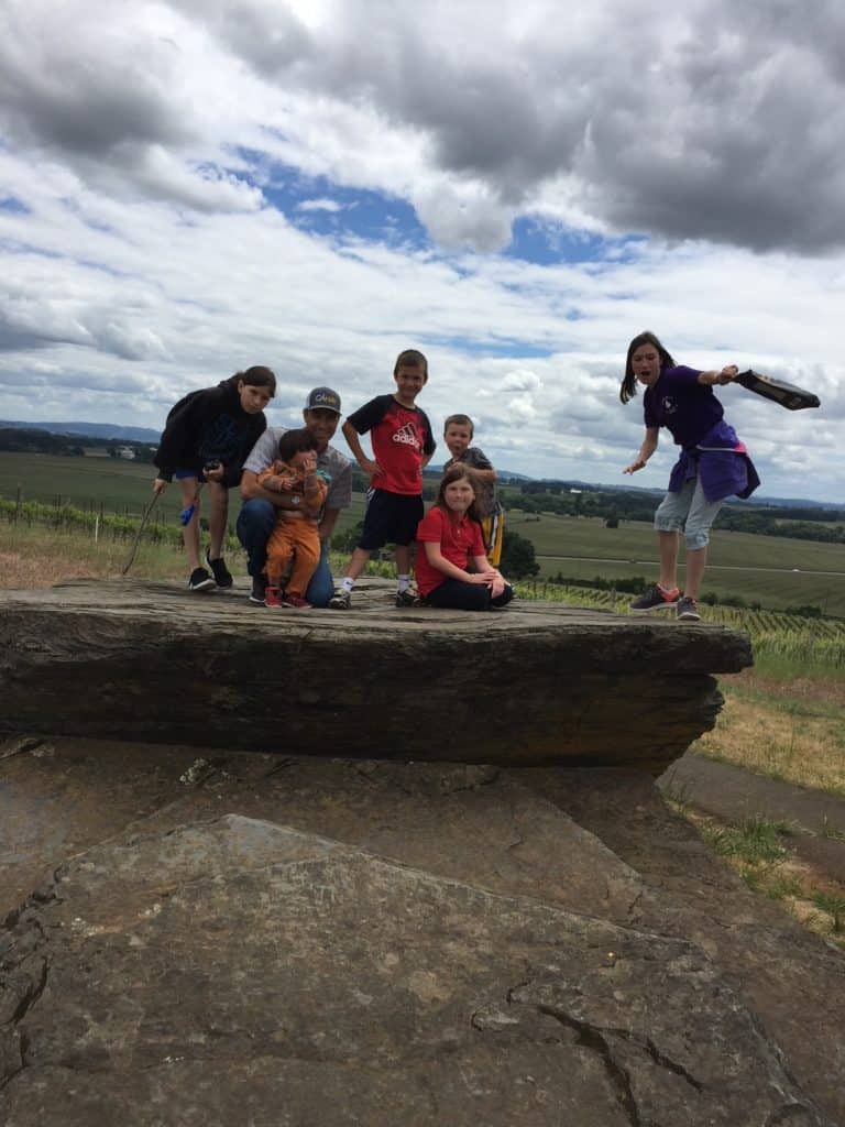 Family on Erratic Rock. Family activities near McMinnville include visiting this small spot as part of the Ice Age Geological Trail.