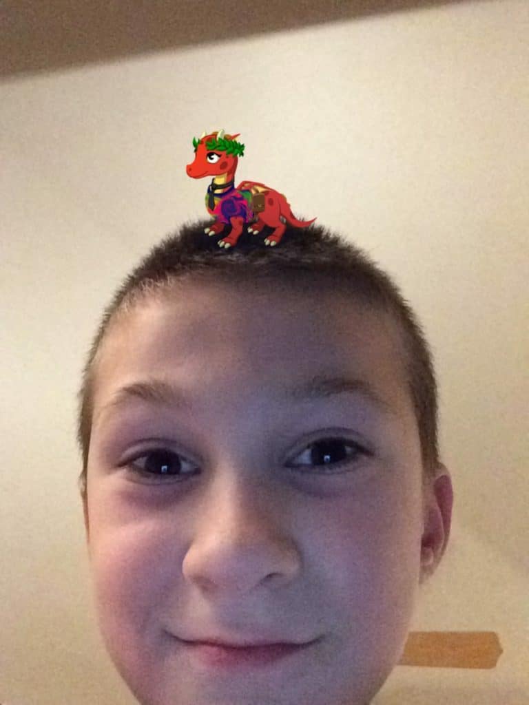Boy with digital animal on head. Joon app helps ADHD families.
